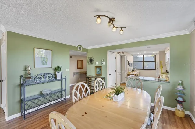 a bedroom with a bed and a flat tv screen on dresser
