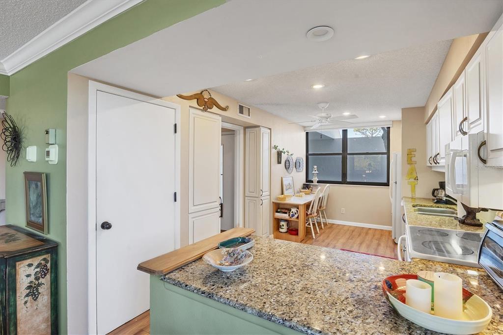 825 Bayport Way, Unit 825 Longboat Key, FL 34228 - Photo 29 of 62 a kitchen with stainless steel appliances granite countertop a sink and a refrigerator