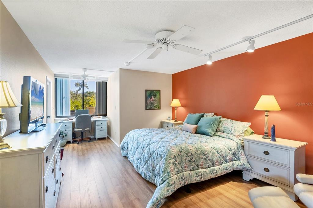 825 Bayport Way, Unit 825 Longboat Key, FL 34228 - Photo 33 of 62 a bedroom with a bed and a chandelier