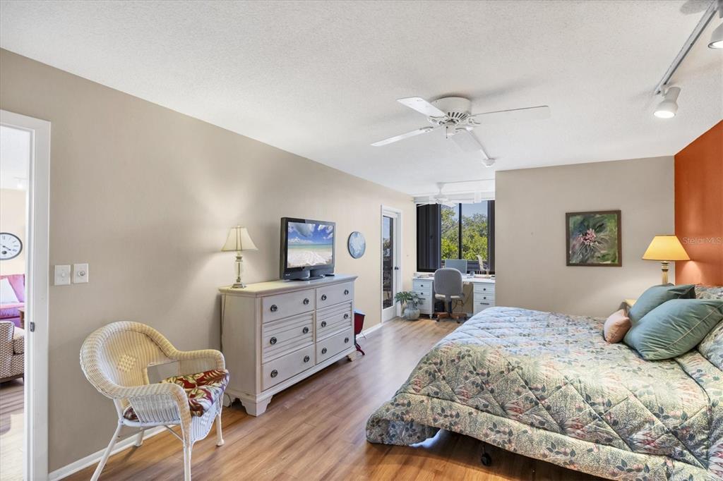 825 Bayport Way, Unit 825 Longboat Key, FL 34228 - Photo 34 of 62 a bedroom with a bed and wooden floor