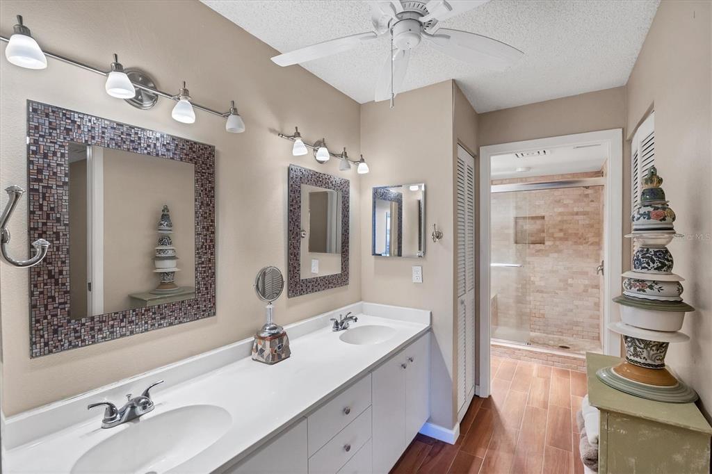 825 Bayport Way, Unit 825 Longboat Key, FL 34228 - Photo 36 of 62 a bathroom with a double vanity sink mirror and shower