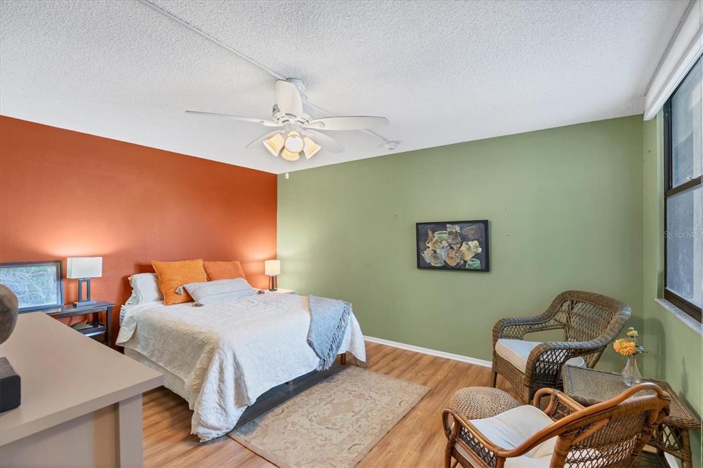 825 Bayport Way, Unit 825 Longboat Key, FL 34228 - Photo 40 of 62 a bedroom with a bed and a chandelier