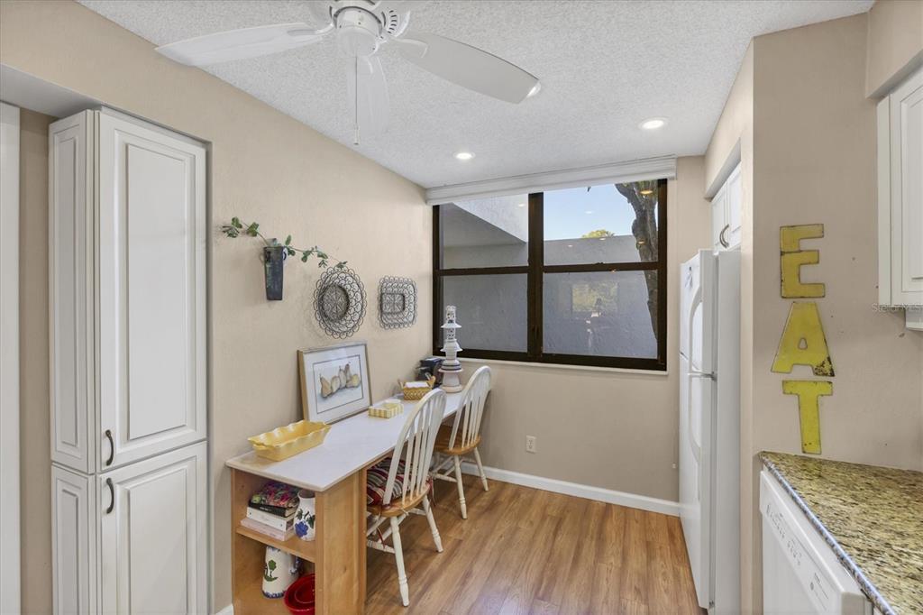 825 Bayport Way, Unit 825 Longboat Key, FL 34228 - Photo 43 of 62 a view of a dining area with furniture and wooden floor