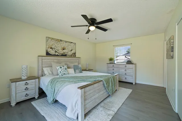 a bedroom with a bed and a chandelier