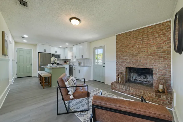 a living room with furniture and a fireplace