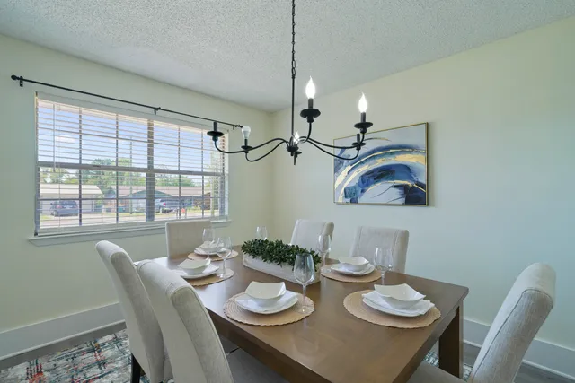 a view of a dining room with furniture large window and wooden floor