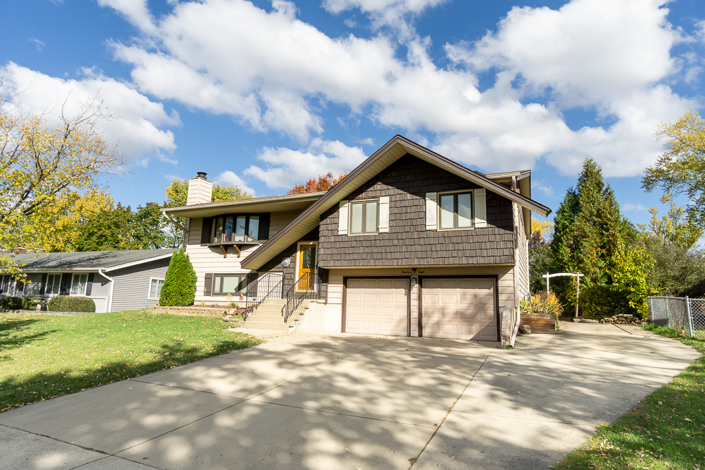 1908 Capri Lane Schaumburg, IL 60193 - Photo 1 of 39 a front view of a house with a garden and trees