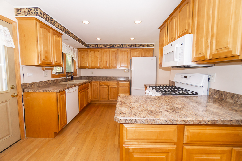 1908 Capri Lane Schaumburg, IL 60193 - Photo 11 of 39 a kitchen with stainless steel appliances granite countertop a sink and cabinets