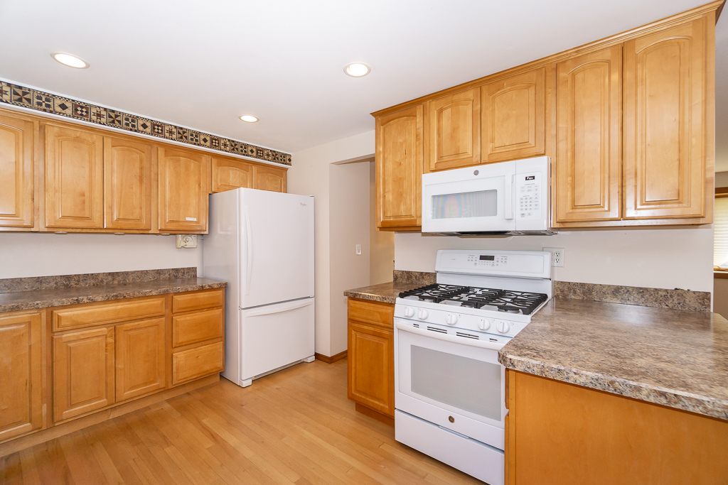 1908 Capri Lane Schaumburg, IL 60193 - Photo 12 of 39 a kitchen with a sink stove and refrigerator