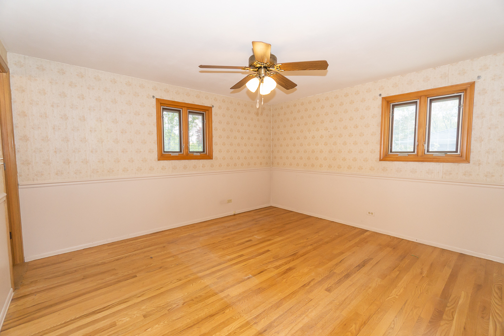 1908 Capri Lane Schaumburg, IL 60193 - Photo 15 of 39 a view of empty room with wooden floor and fan
