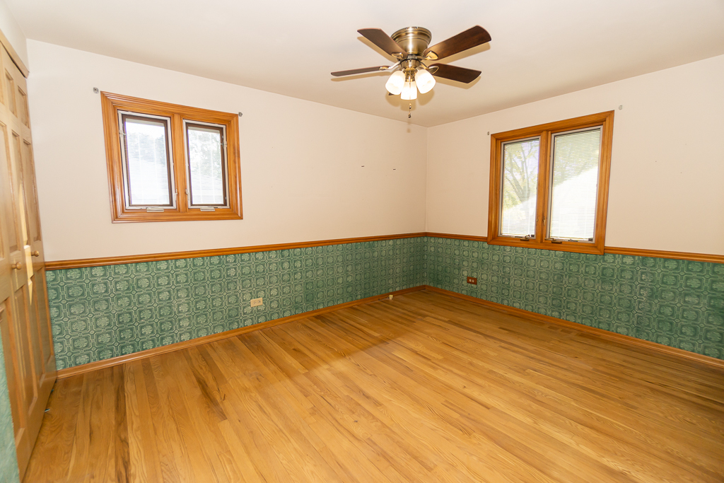 1908 Capri Lane Schaumburg, IL 60193 - Photo 19 of 39 a view of an empty room with a window and wooden floor