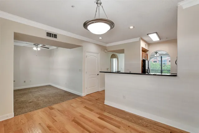 a view of empty room with window and ceiling fan