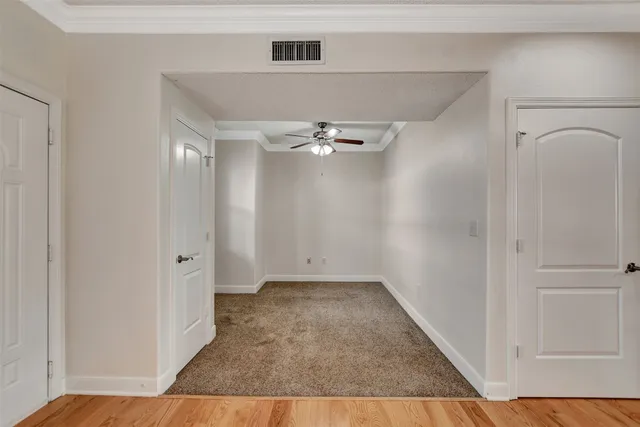 a view of a room with wooden floor