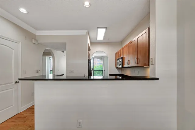 a kitchen with stainless steel appliances granite countertop a sink a stove and cabinets