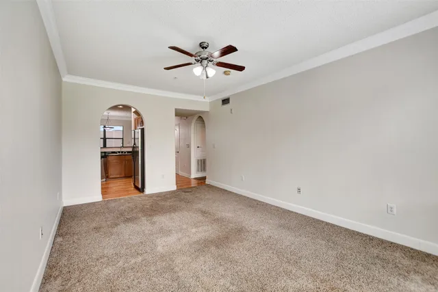 an empty room with closet and windows