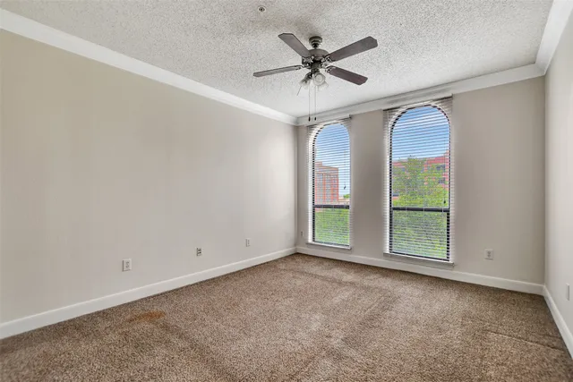 a view of empty room with ceiling fan