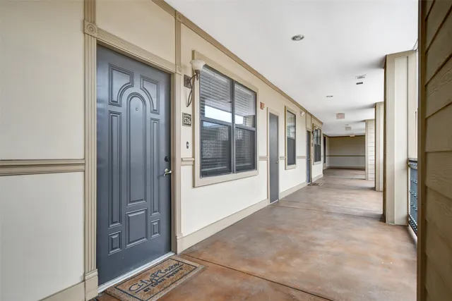 a view of a hallway with wooden shelves