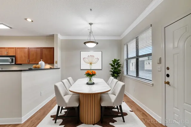 a view of a dining room with furniture and wooden floor