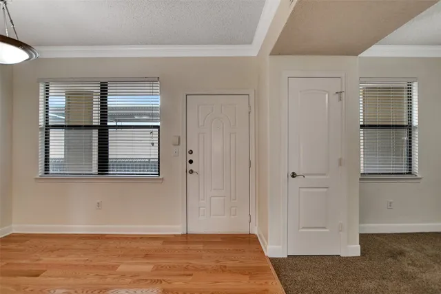 a view of a room with wooden floor and a window