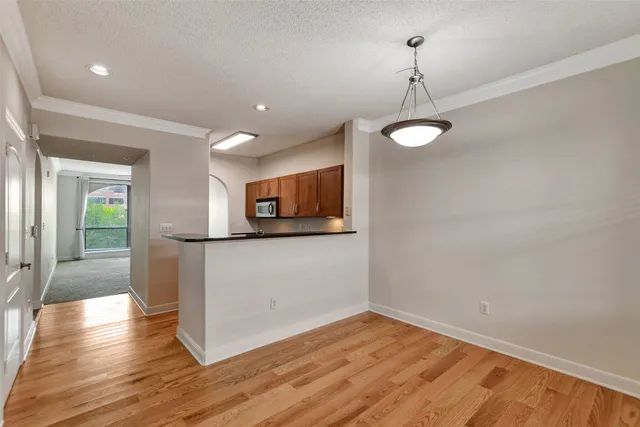 a view of a room with wooden floor and a window