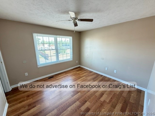 6467 Yadkin Road, Unit 1 Fayetteville, NC 28303 - Photo 7 of 9 an empty room with wooden floor and windows