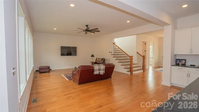 a view of a living room with wooden floor and furniture