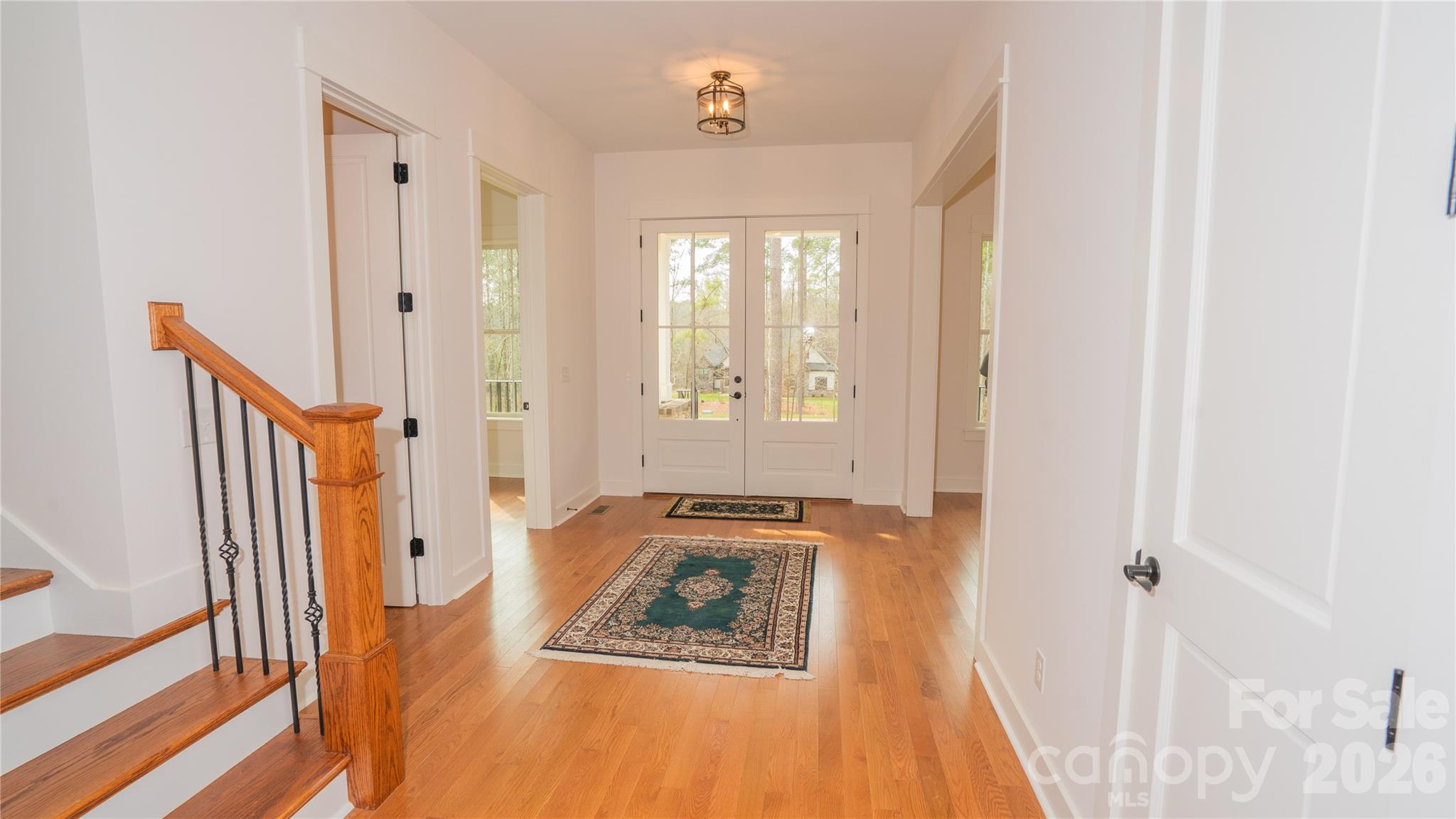 6178 Chimney Bluff Road Lancaster, SC 29720 - Photo 15 of 34 a view of a hallway to a bedroom with wooden floor and front door