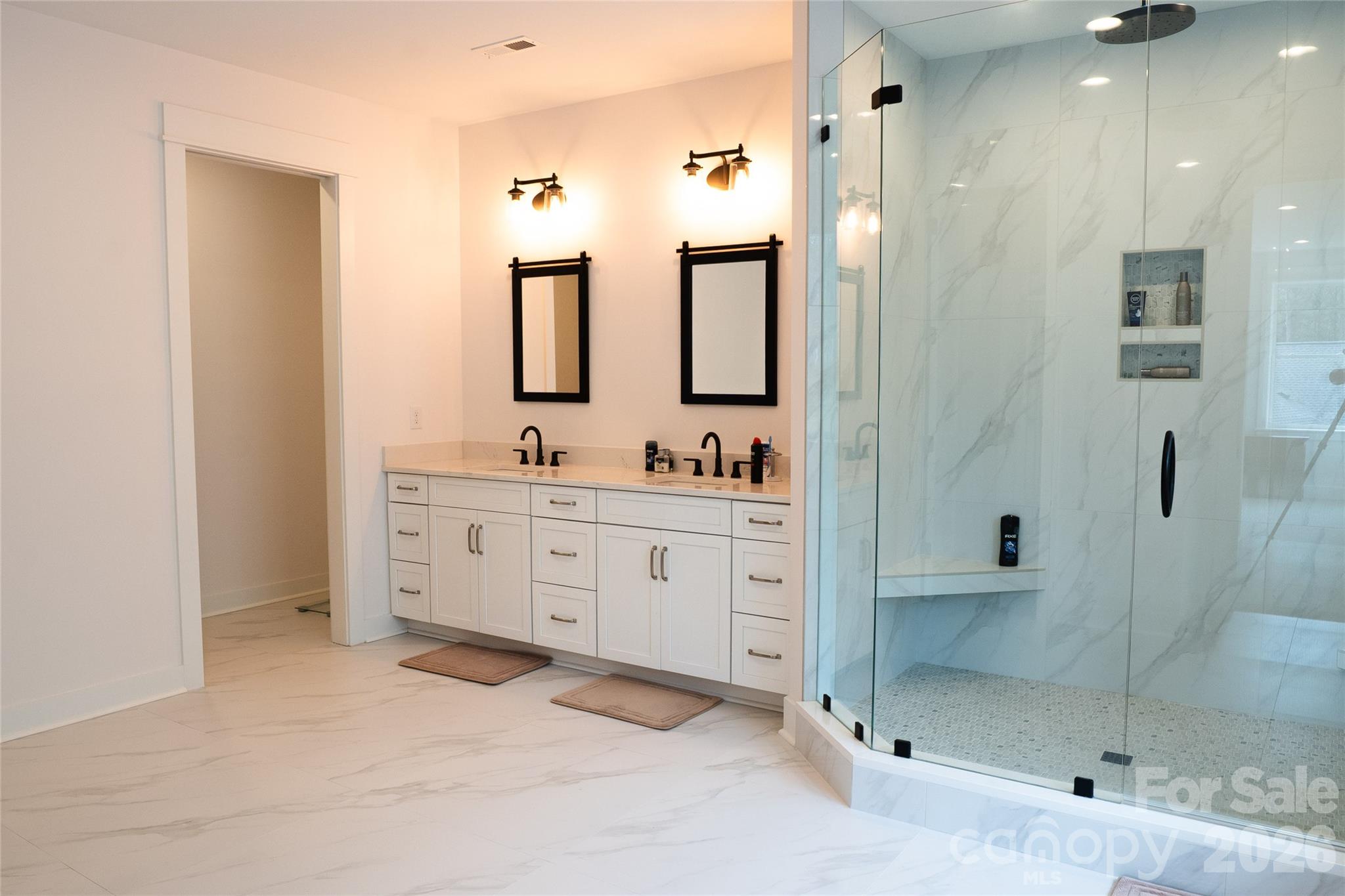 6178 Chimney Bluff Road Lancaster, SC 29720 - Photo 23 of 34 a spacious bathroom with a shower sink and mirror