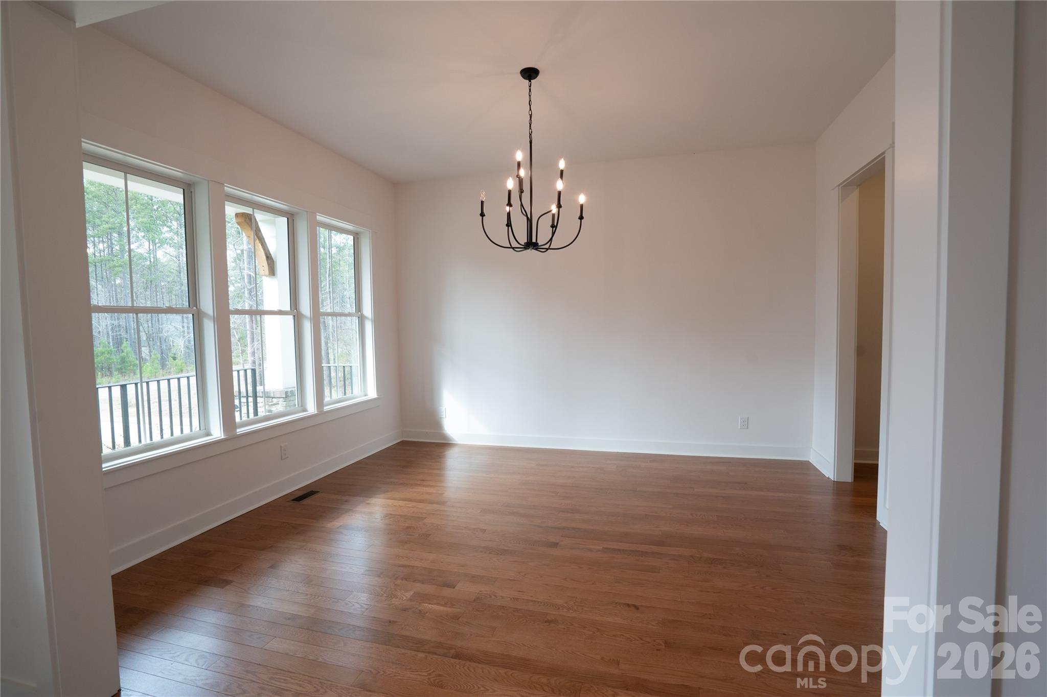 6178 Chimney Bluff Road Lancaster, SC 29720 - Photo 7 of 34 a view of a room with wooden floor chandelier and windows