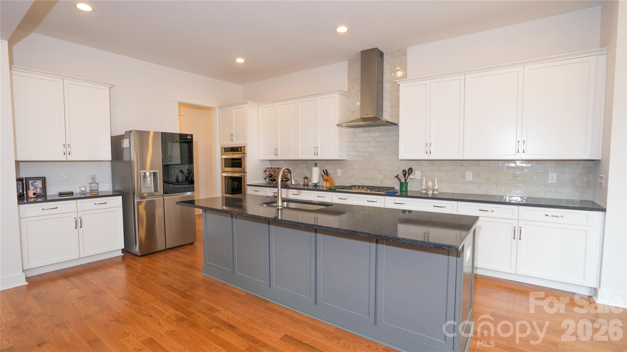 6178 Chimney Bluff Road Lancaster, SC 29720 - Photo 8 of 34 a kitchen with stainless steel appliances granite countertop a refrigerator sink and white cabinets