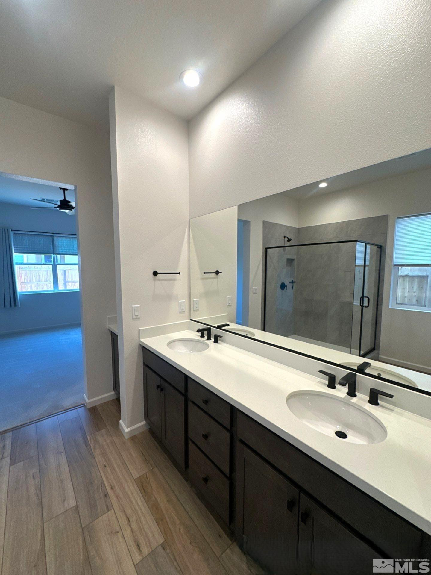 2494 Metolius Drive Sparks, NV 89436 - Photo 11 of 22 a bathroom with a double vanity sink and mirror