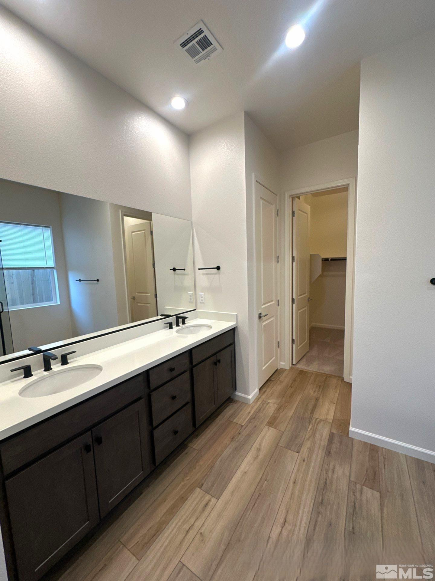 2494 Metolius Drive Sparks, NV 89436 - Photo 12 of 22 a spacious bathroom with a double vanity sink and mirror