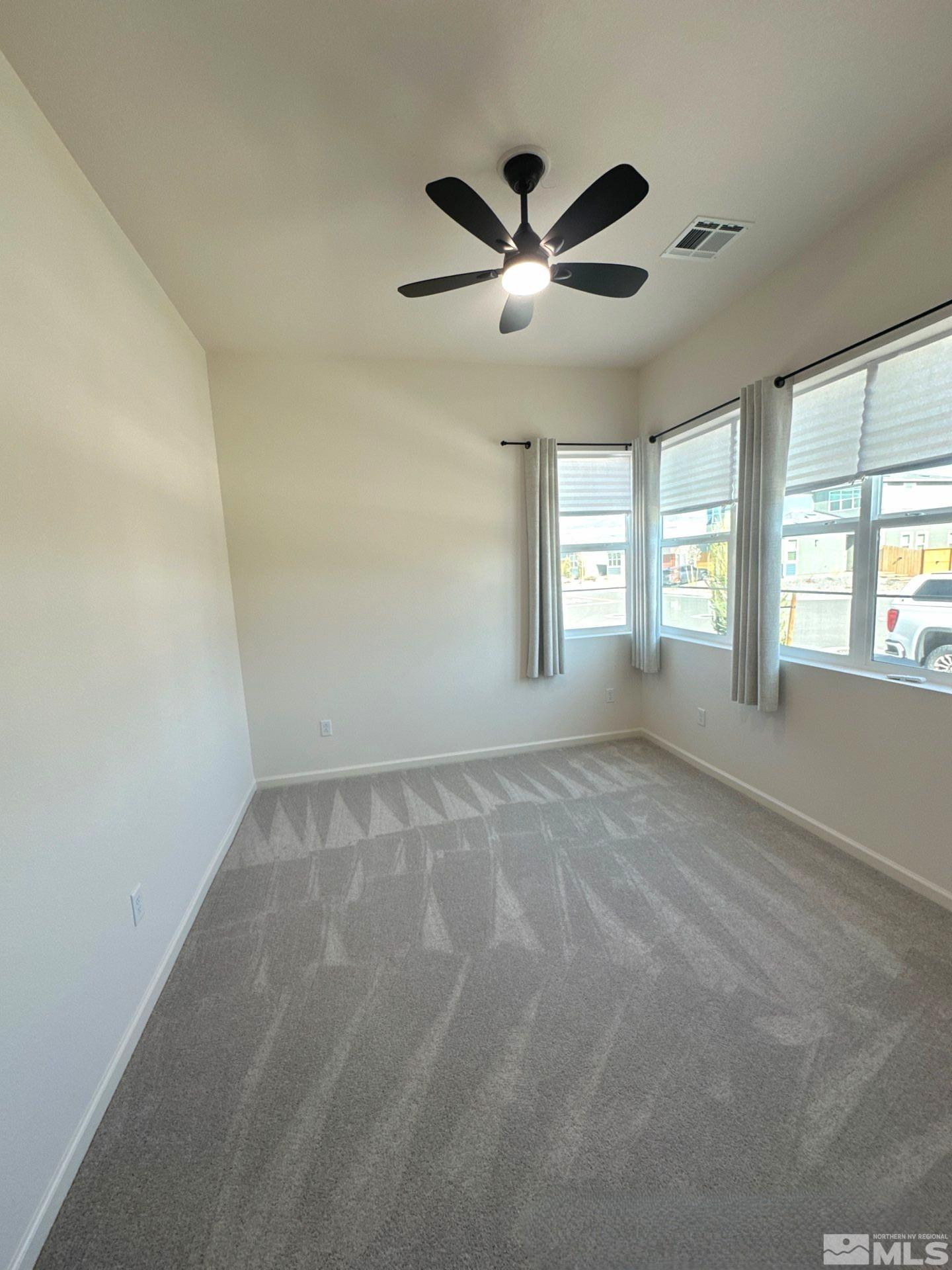 2494 Metolius Drive Sparks, NV 89436 - Photo 15 of 22 a view of an empty room with chandelier fan and fire place