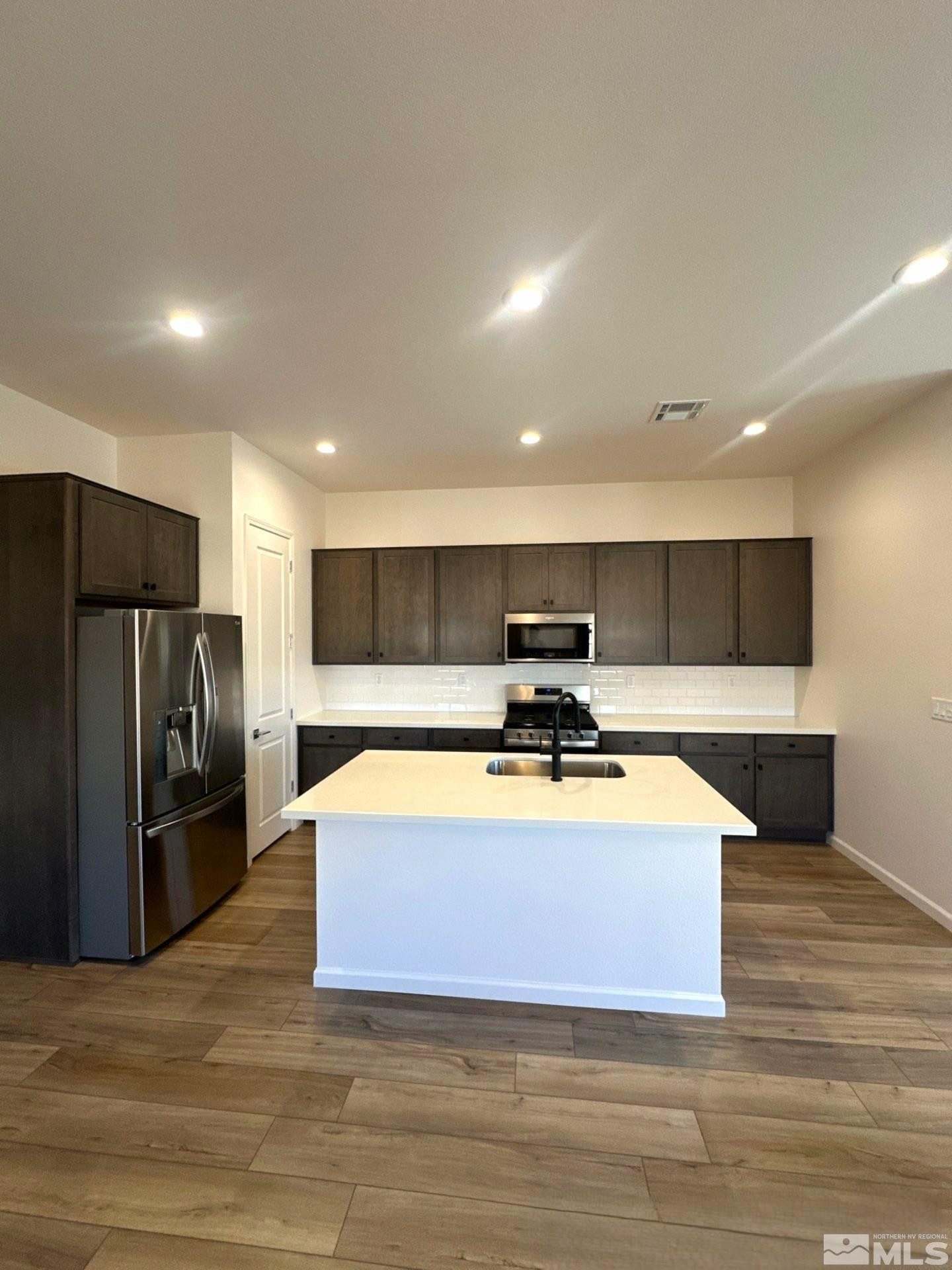 2494 Metolius Drive Sparks, NV 89436 - Photo 4 of 22 a kitchen with stainless steel appliances a refrigerator and a stove