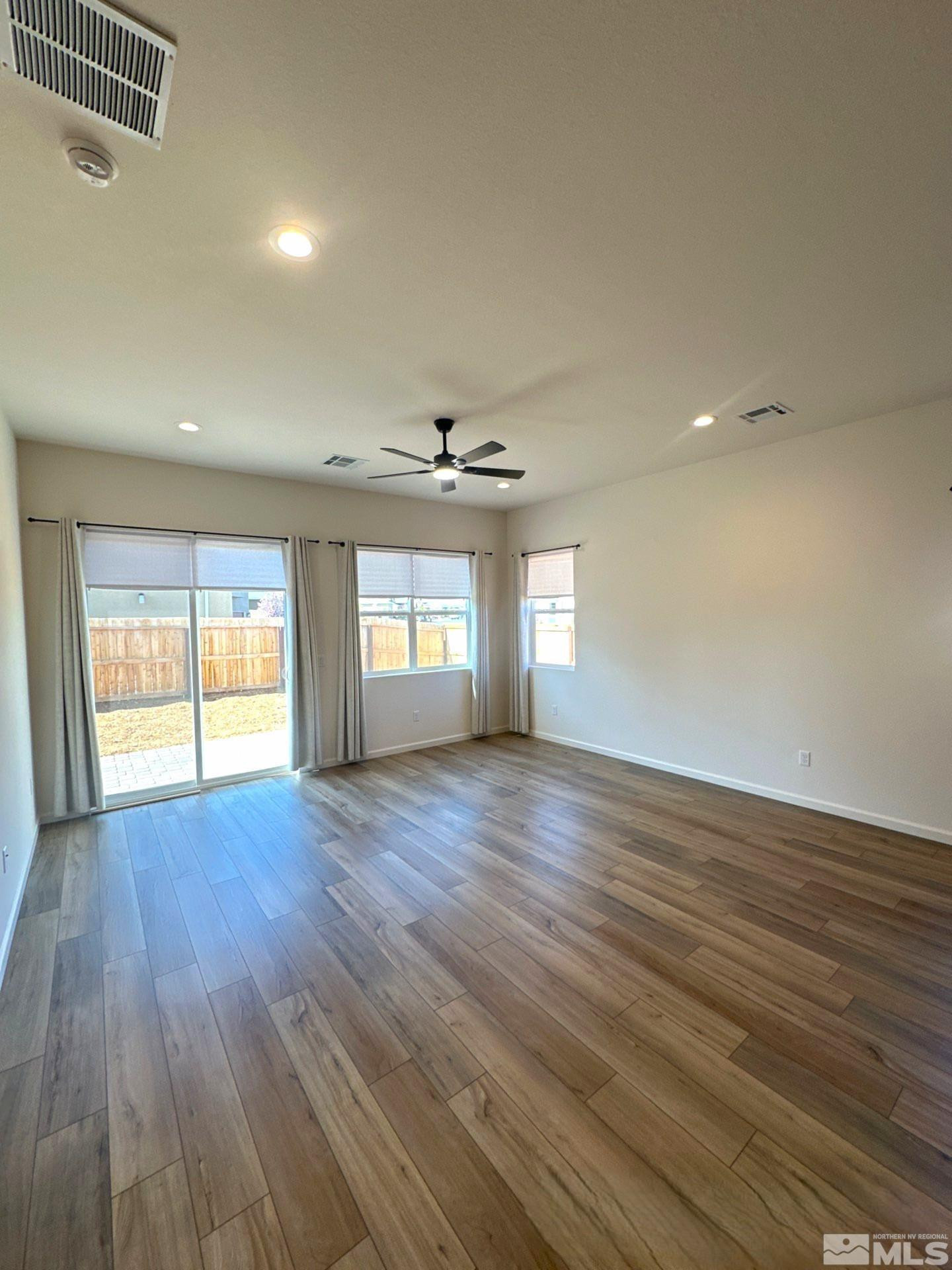 2494 Metolius Drive Sparks, NV 89436 - Photo 7 of 22 an empty room with wooden floor and windows