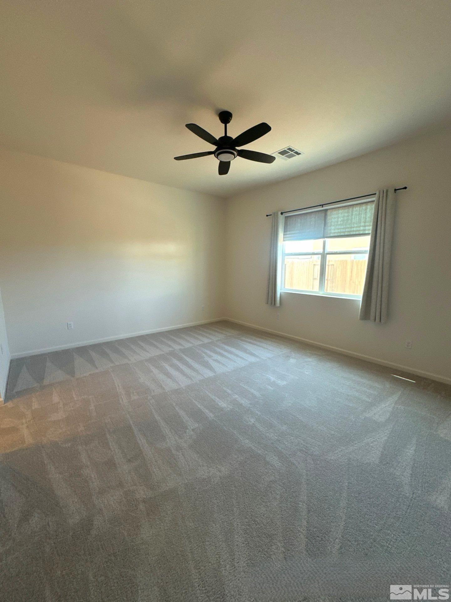 2494 Metolius Drive Sparks, NV 89436 - Photo 9 of 22 an empty room with windows and ceiling fan view