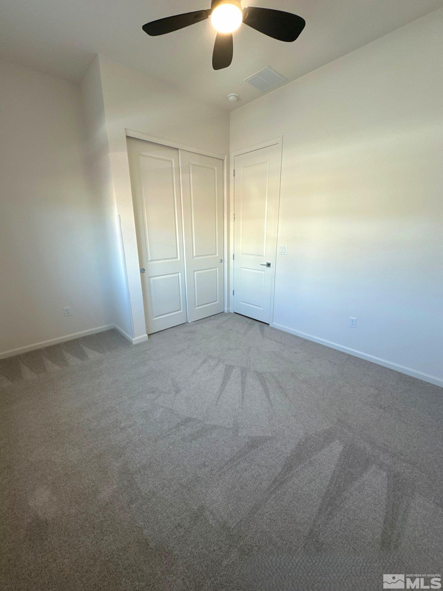 2494 Metolius Drive Sparks, NV 89436 - Photo 10 of 22 an empty room with windows and fan