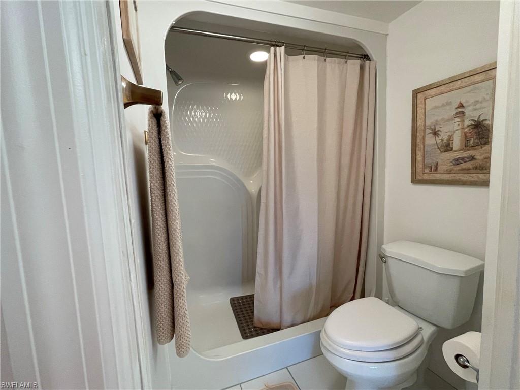 153 Gabriel Circle, Unit 3003 Naples, FL 34104 - Photo 12 of 38 a bathroom with a toilet and a shower