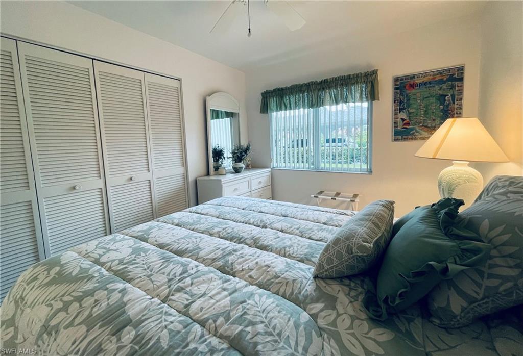 153 Gabriel Circle, Unit 3003 Naples, FL 34104 - Photo 14 of 38 a bedroom with a bed and window
