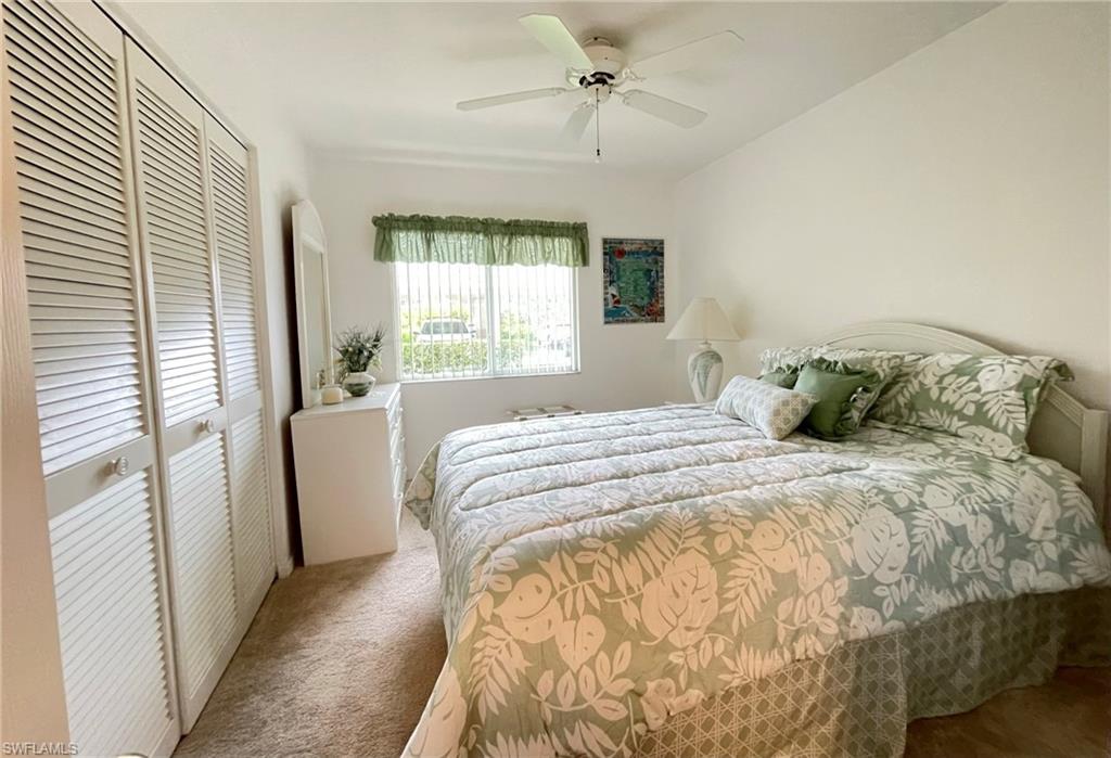 153 Gabriel Circle, Unit 3003 Naples, FL 34104 - Photo 15 of 38 a bedroom with a bed and a window
