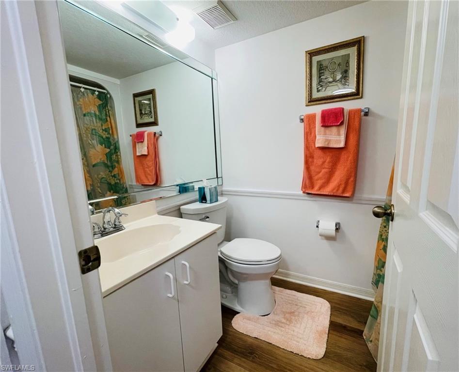 153 Gabriel Circle, Unit 3003 Naples, FL 34104 - Photo 16 of 38 a bathroom with a toilet sink and mirror