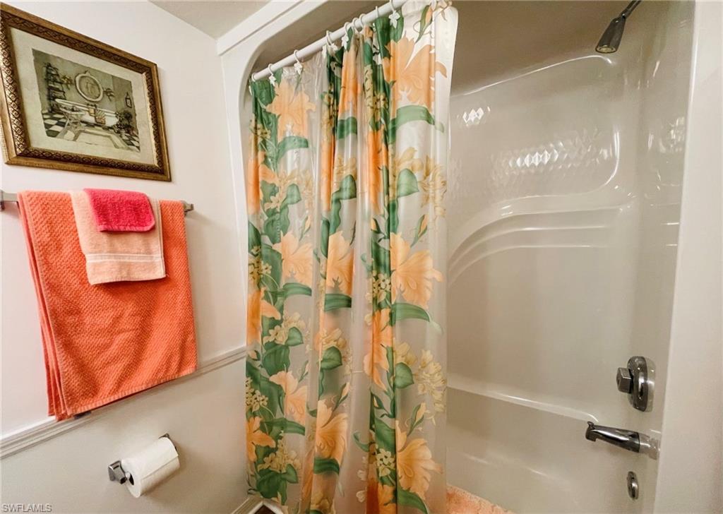 153 Gabriel Circle, Unit 3003 Naples, FL 34104 - Photo 17 of 38 a bathroom with a bathtub and shower