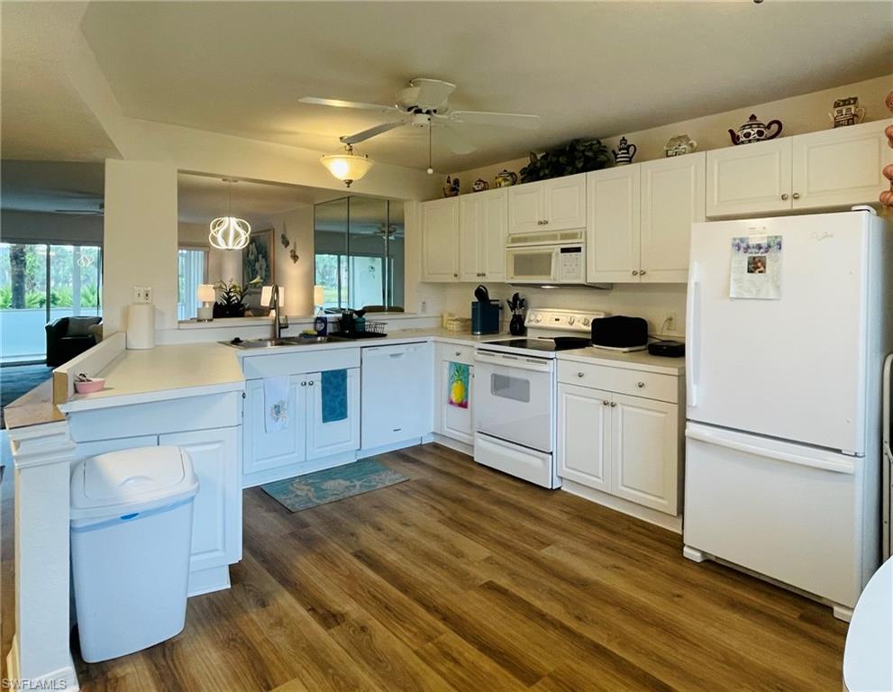 153 Gabriel Circle, Unit 3003 Naples, FL 34104 - Photo 18 of 38 a kitchen with cabinets a sink and white appliances