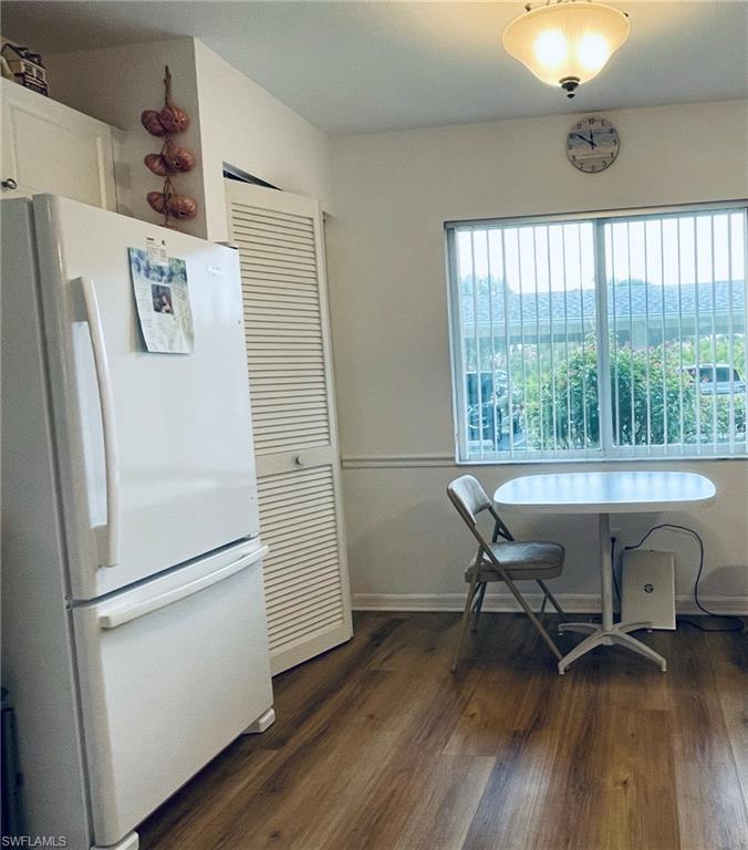 153 Gabriel Circle, Unit 3003 Naples, FL 34104 - Photo 20 of 38 a view of dining room with wooden floor and a window