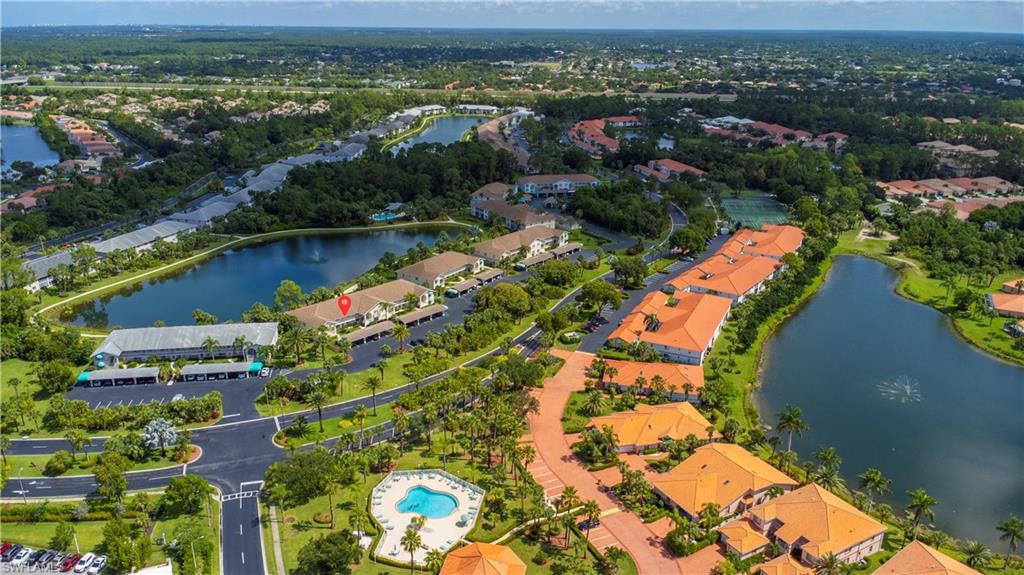 153 Gabriel Circle, Unit 3003 Naples, FL 34104 - Photo 2 of 38 an aerial view of lake and residential houses with outdoor space