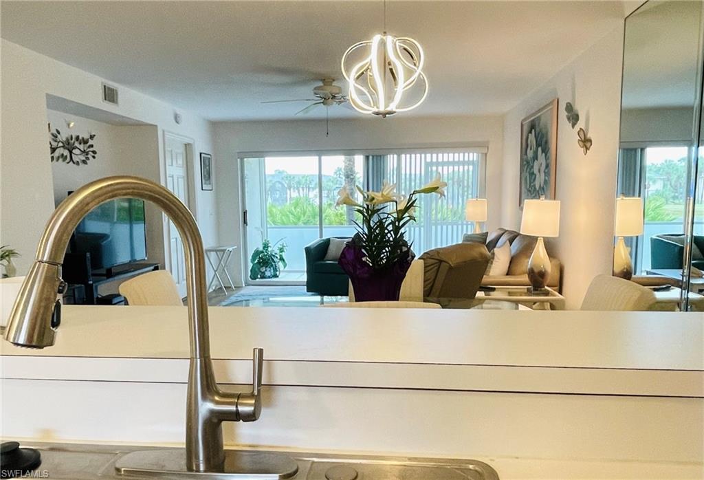 153 Gabriel Circle, Unit 3003 Naples, FL 34104 - Photo 21 of 38 a bathroom with a sink and a mirror