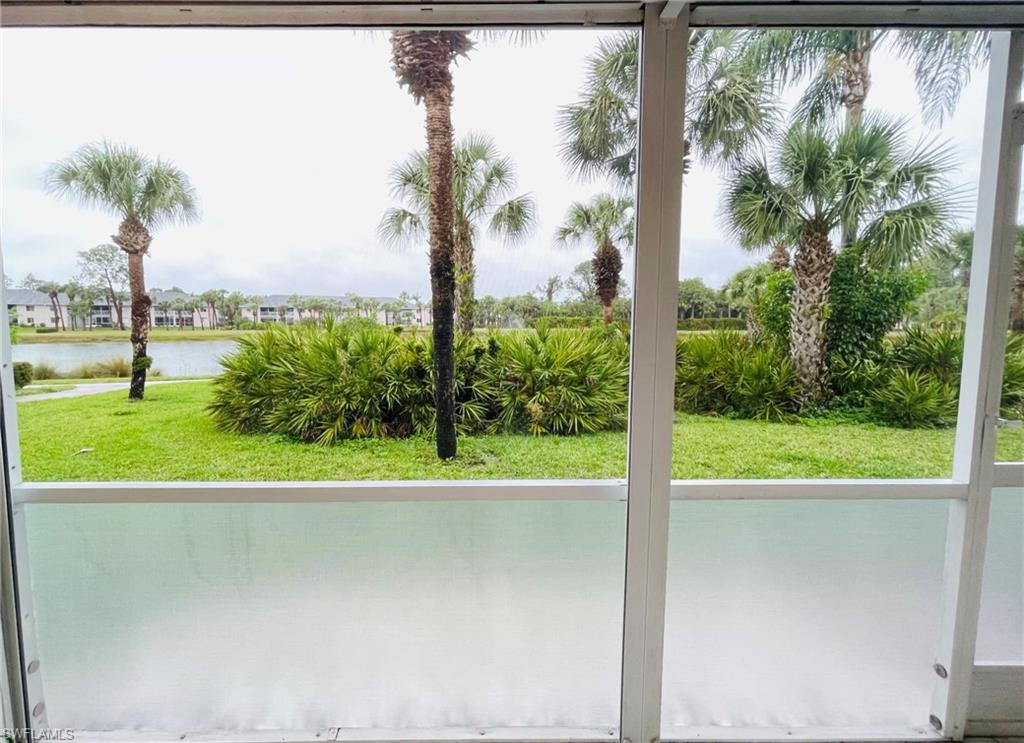153 Gabriel Circle, Unit 3003 Naples, FL 34104 - Photo 24 of 38 a view of a room with a floor to ceiling windows and palm tree
