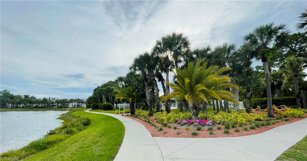 153 Gabriel Circle, Unit 3003 Naples, FL 34104 - Photo 29 of 38 a garden with flowers and trees