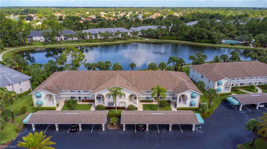 153 Gabriel Circle, Unit 3003 Naples, FL 34104 - Photo 3 of 38 an aerial view of house with a garden and lake view