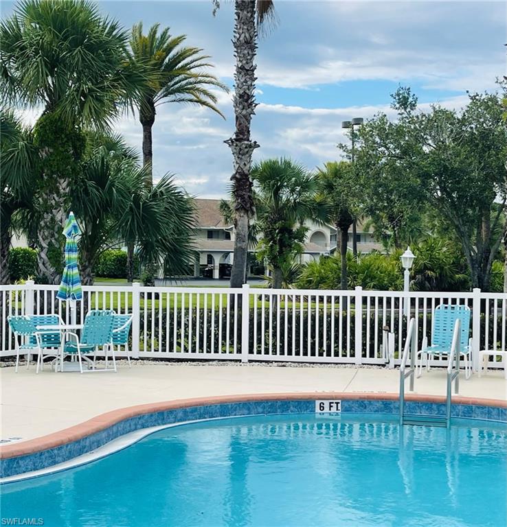 153 Gabriel Circle, Unit 3003 Naples, FL 34104 - Photo 35 of 38 a view of balcony with wooden floor and lake view